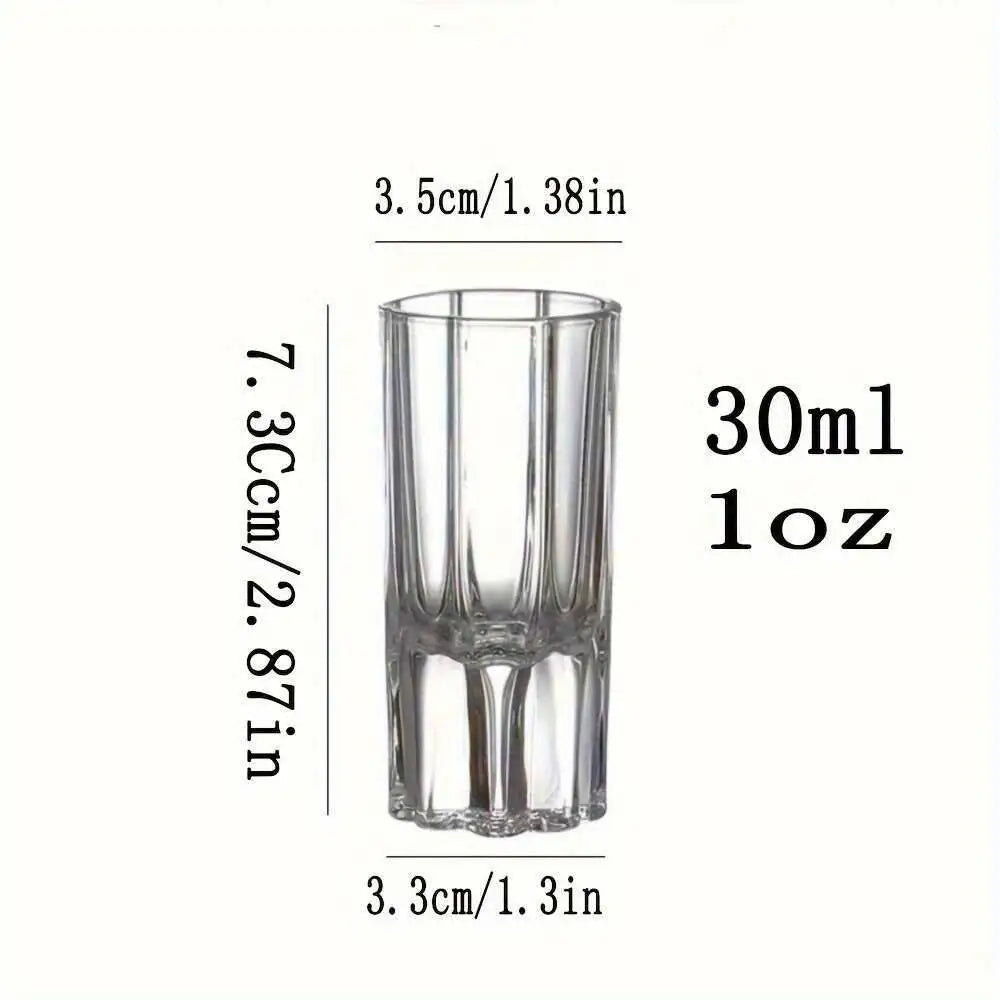 Clear glass shot glass with measurements on a white background