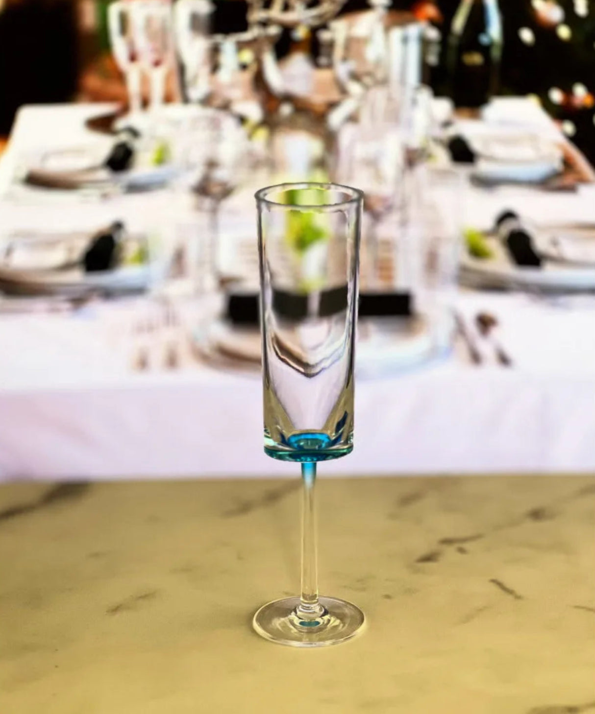 Clear glass with blue base on a table setting