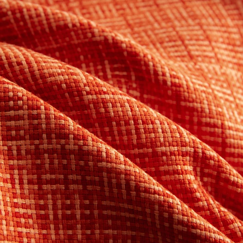 Close-up of orange fabric with a subtle pattern