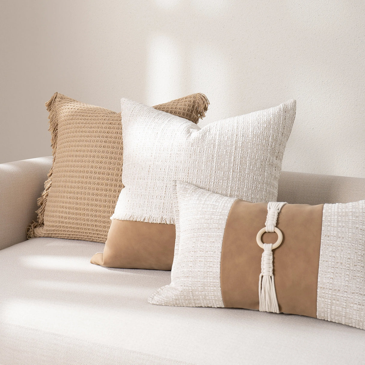 Decorative pillows on a sofa with a neutral color palette
