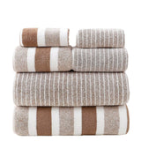 Stack of striped towels in brown, beige, and white on a white background