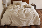 Beige textured duvet on a bed in a bedroom setting