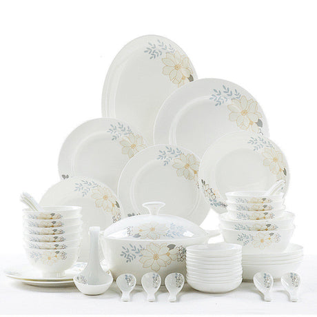 Set of white ceramic dinnerware with floral patterns on a white background