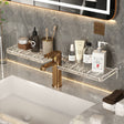 Bathroom vanity with marble shelf, faucet, and toiletries against a gray marble wall.