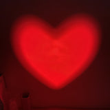 Red heart-shaped light on a dark background