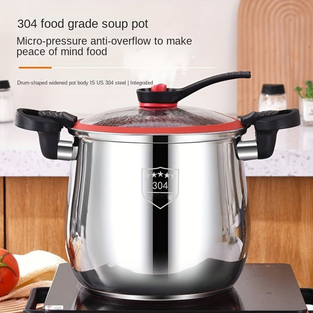Stainless steel soup pot with red lid on a stove, kitchen setting