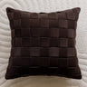 Brown woven pillow on a textured beige background