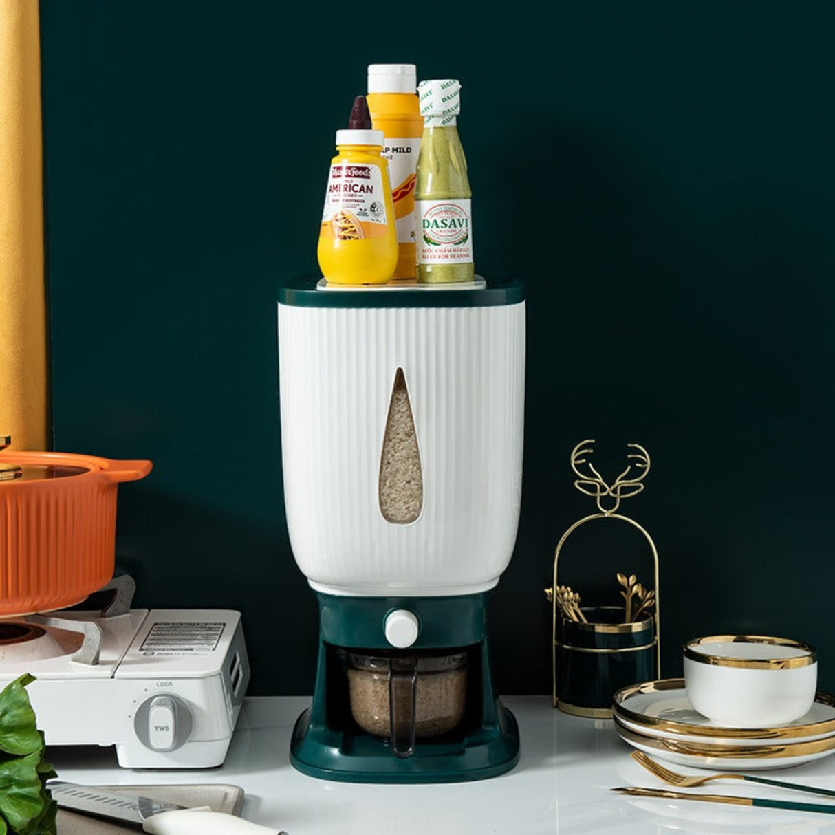 White and green kitchen appliance on a counter with bottles on top against a dark background