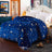 Blue star and moon patterned comforter on a bed in a bedroom setting.