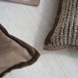 Close-up of two textured pillows on a light-colored surface