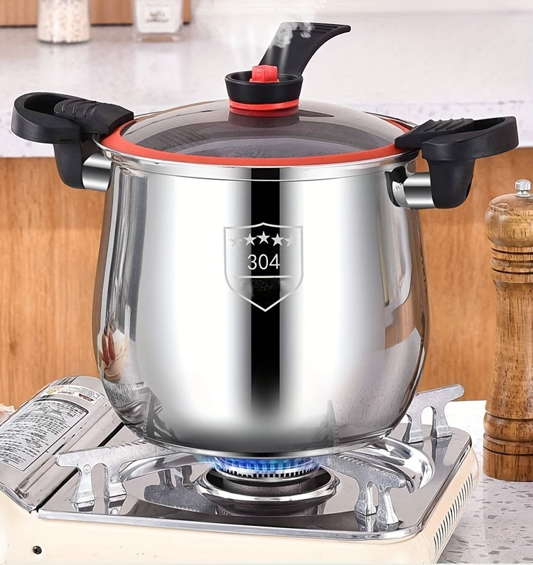 Stainless steel pot with a lid on a gas stove
