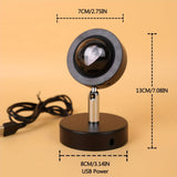 Black magnifying glass with USB power cable on a beige background, showing dimensions.