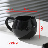Adorable hand - painted cat - shaped ceramic mug, perfect for coffee or tea.