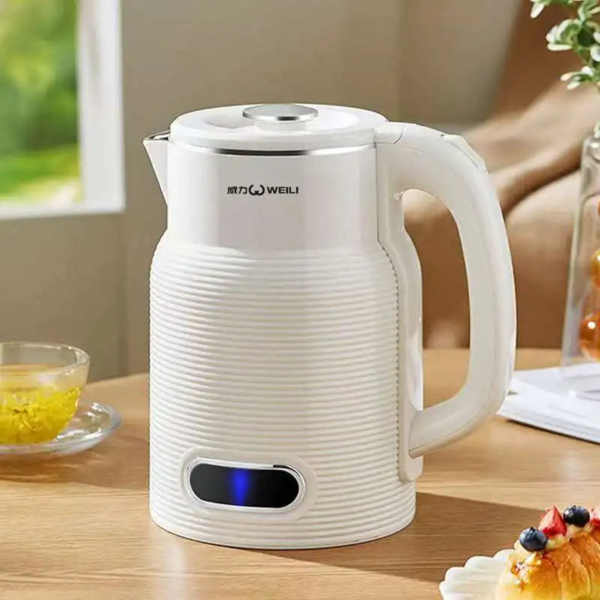 White electric kettle on a wooden table with a blurred background