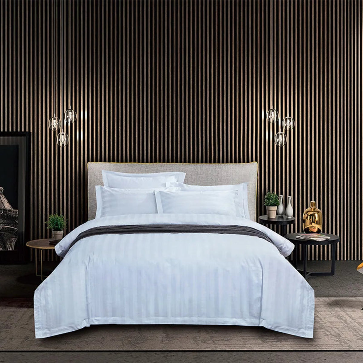 Modern bedroom with a bed, nightstands, and decorative items against a striped wall.