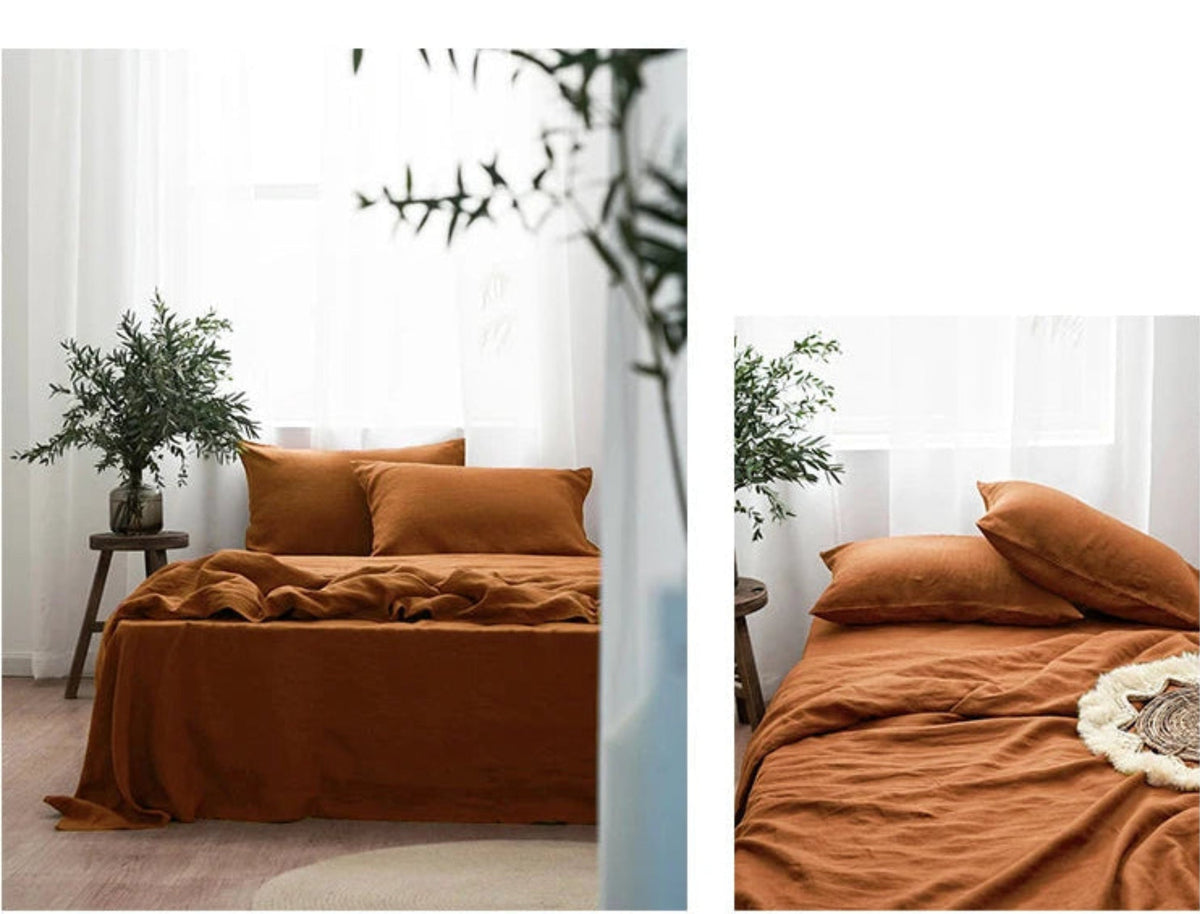 Brown bedding set on a bed with a side table and plant in a neutral room.