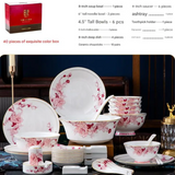 Ceramic dinnerware set with floral design on a dark background