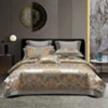 Decorative bedspread with intricate patterns on a bed in a bedroom setting.