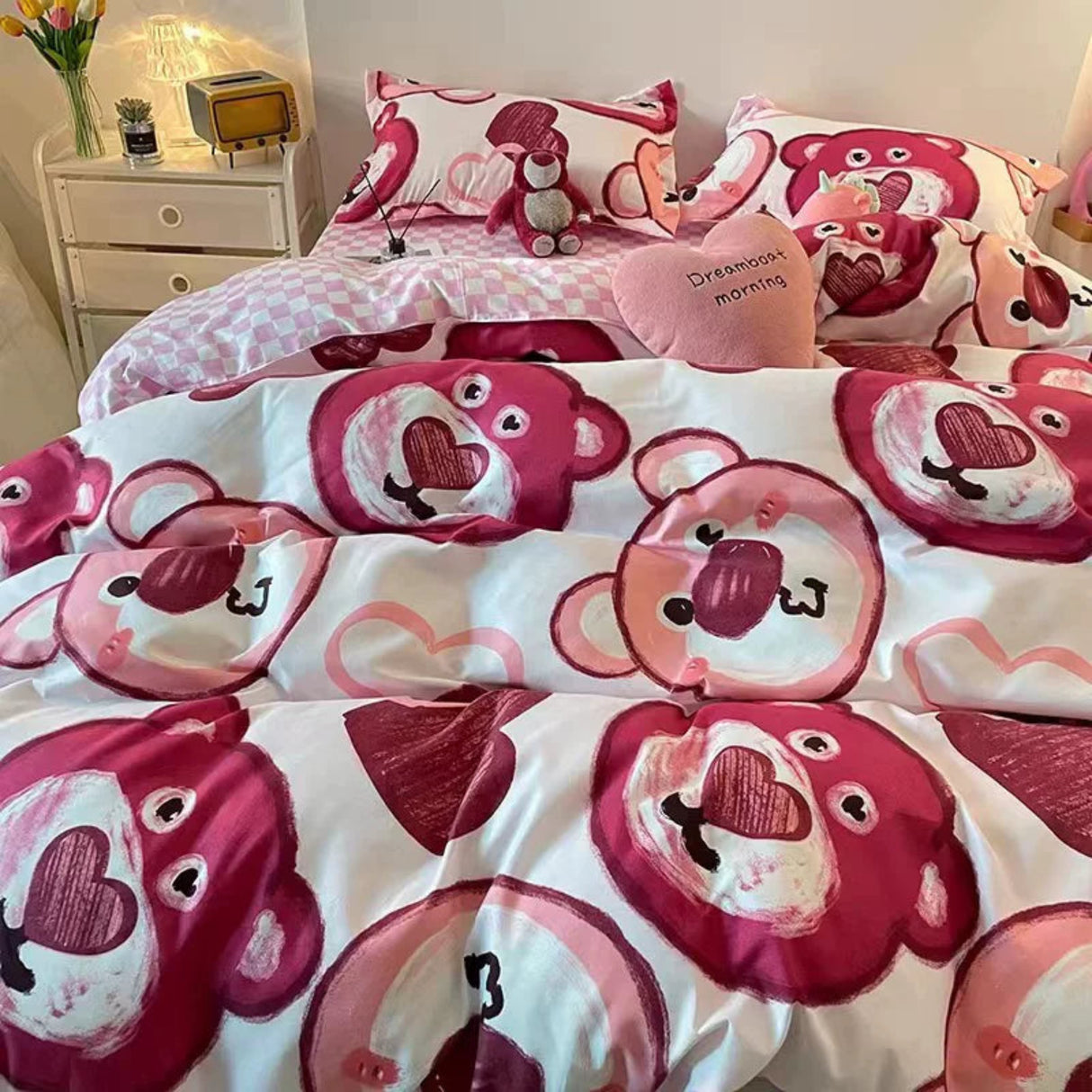 Bedding set with cartoon bear design on a bed in a bedroom setting.