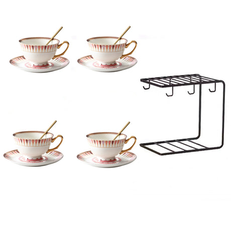 Set of four ceramic tea cups with saucers and a black metal shelf on a white background