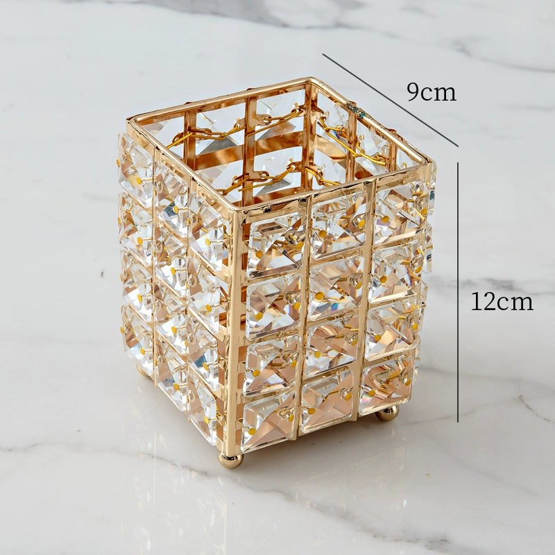 Gold decorative pen holder with measurements on a marble surface