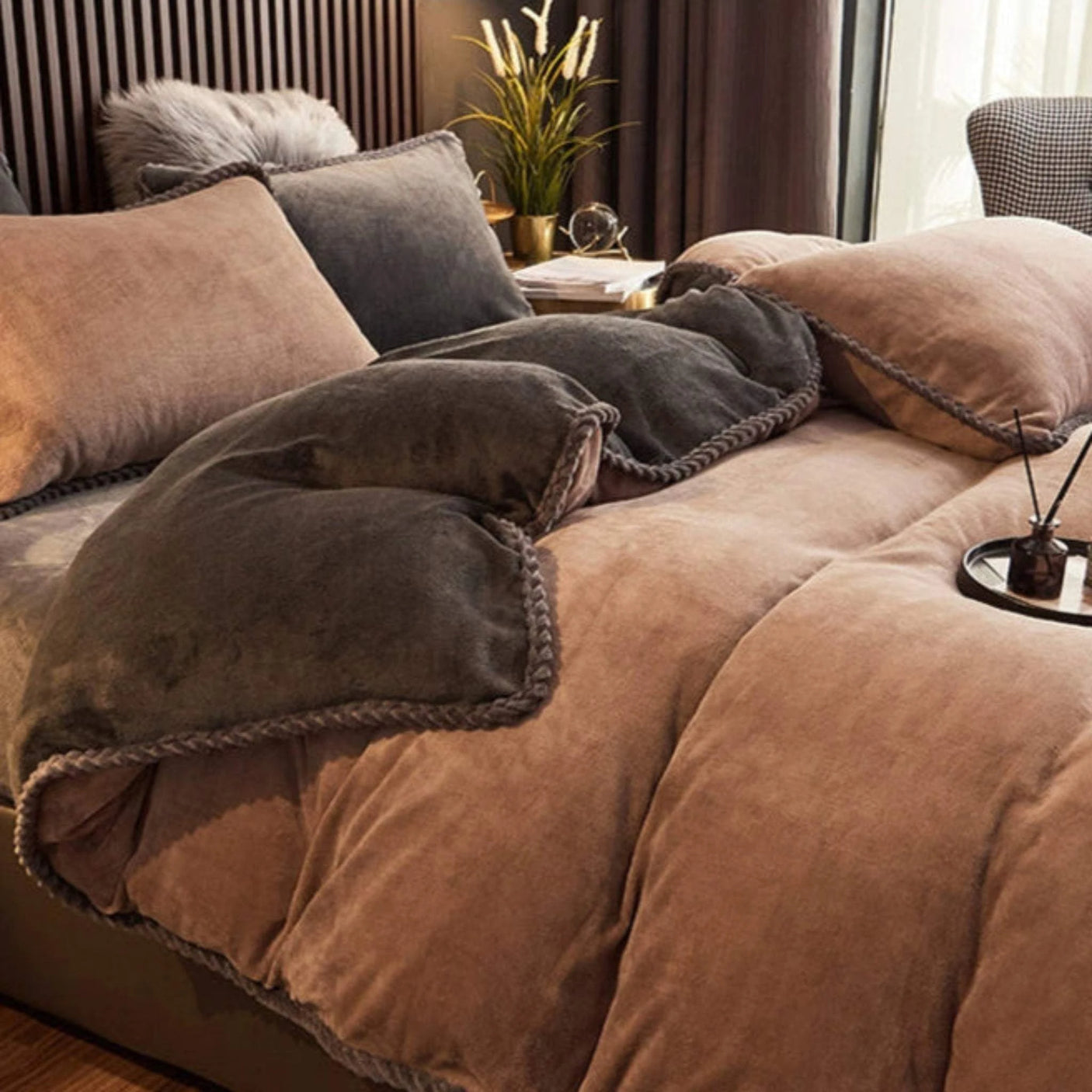 Brown bedding set on a bed in a bedroom with decorative elements.