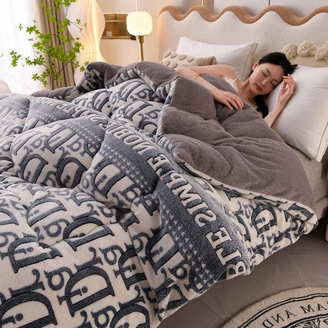 Woman lying in bed under a patterned blanket with a neutral background