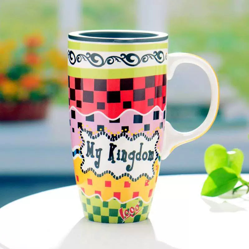 Colorful mug with 'My Kingdom' text on a blurred natural background