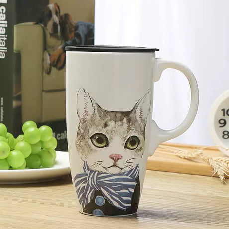 Mug with a cat design on a table with grapes and books in the background