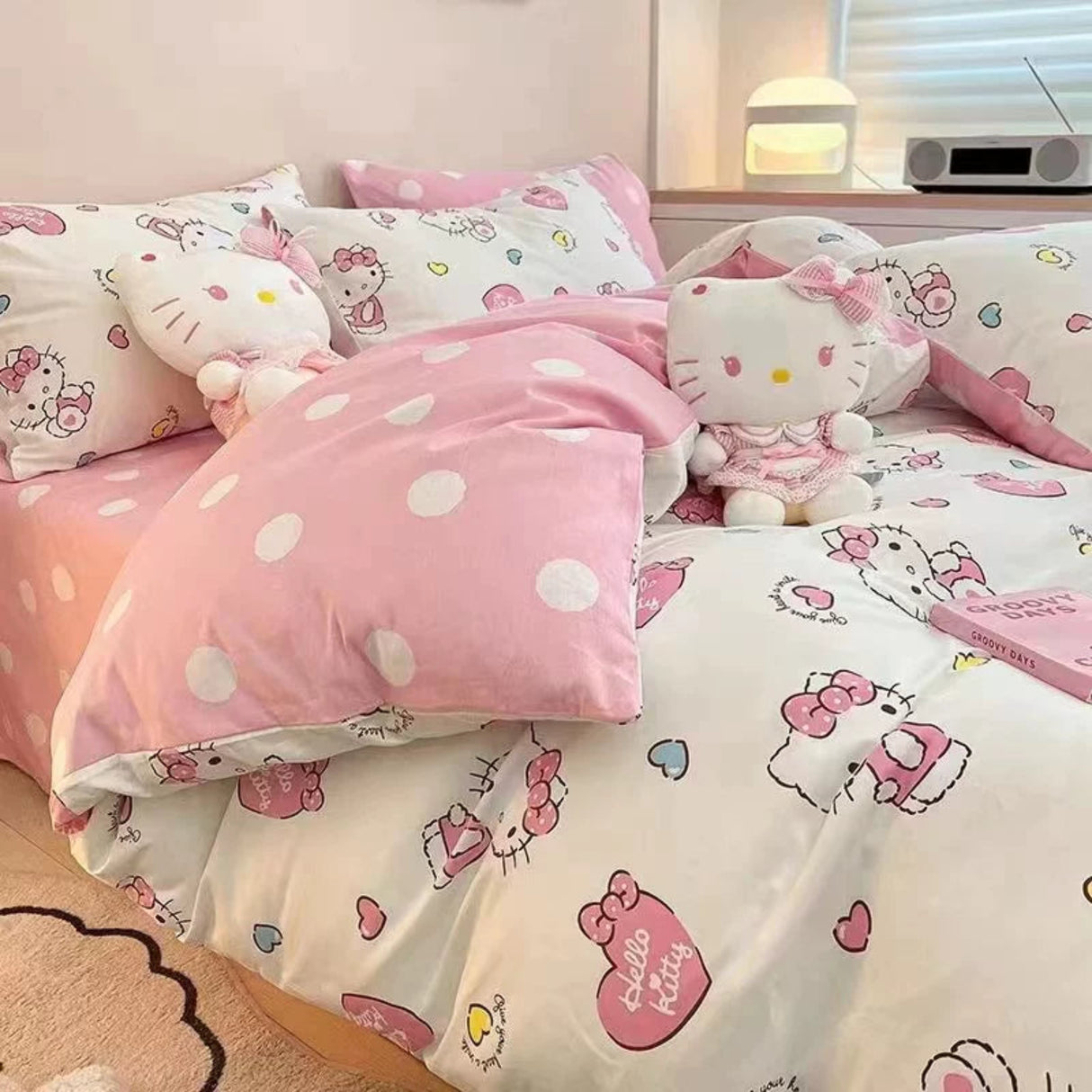 Hello Kitty themed bedding set with pink polka dot comforter and plush toy.