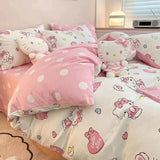 Hello Kitty themed bedding set with pink polka dot comforter and plush toy.