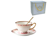 Teacup and saucer set with a spoon on a white background, featuring 'Royal Lo'Queen' branding.