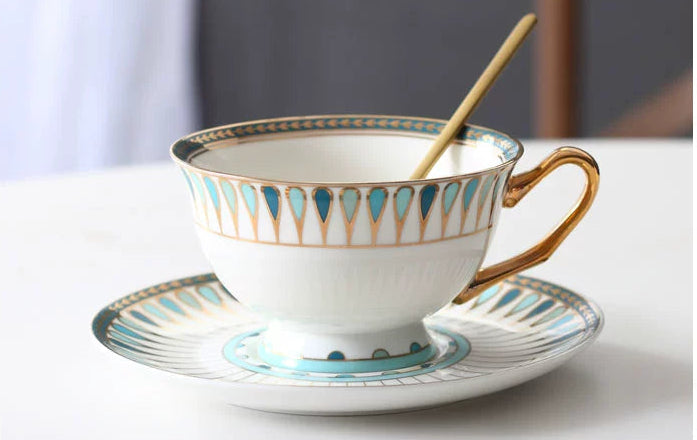 Ceramic cup and saucer with decorative patterns on a white background
