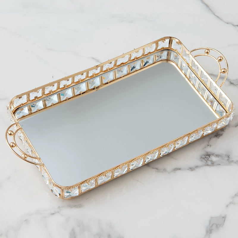 Decorative tray with crystal embellishments on a marble surface