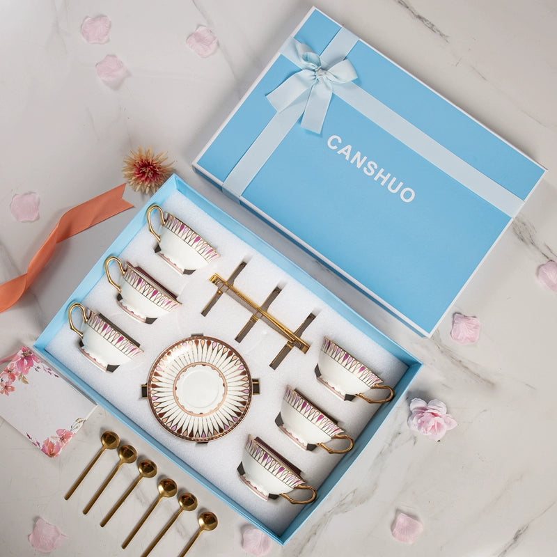Canshuo tea set with rose gold cups, saucers, and a basket in a blue box on a light background.