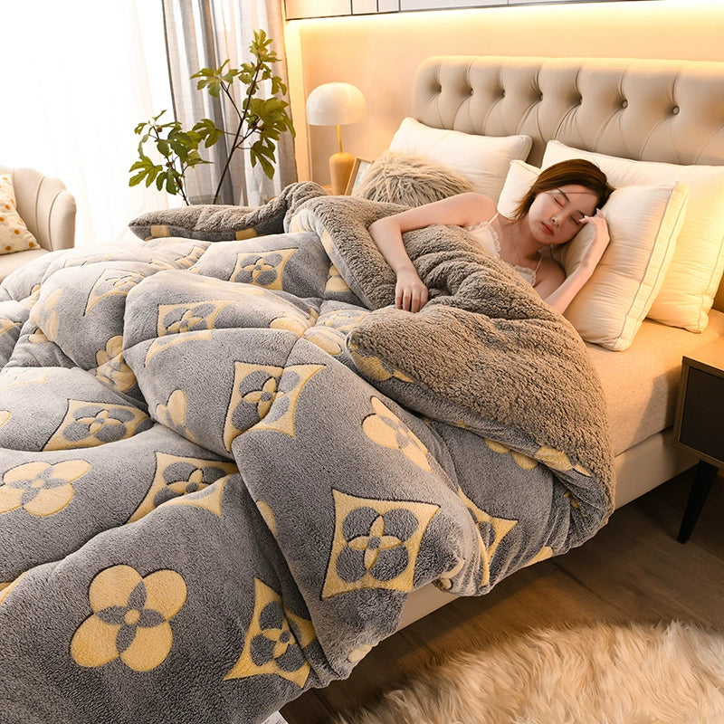 Woman lying on a bed with a floral patterned comforter in a cozy bedroom.