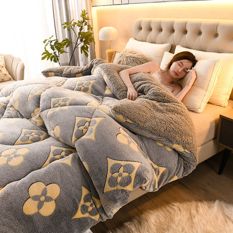 Woman lying on a bed with a floral patterned comforter in a cozy bedroom.