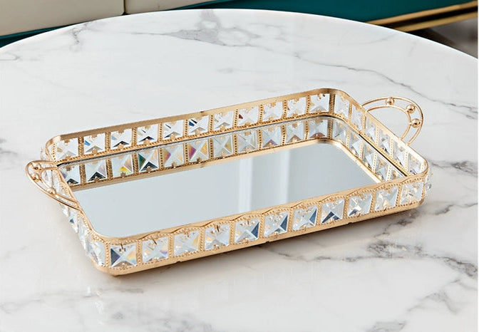 Decorative tray with crystal embellishments on a marble surface