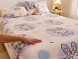 Bedding set with cartoon design on a bed, featuring a hand touching the fabric.