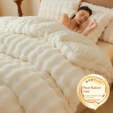 Person sleeping under a fluffy white comforter with a 'Real Rabbit Hair' label in the corner.