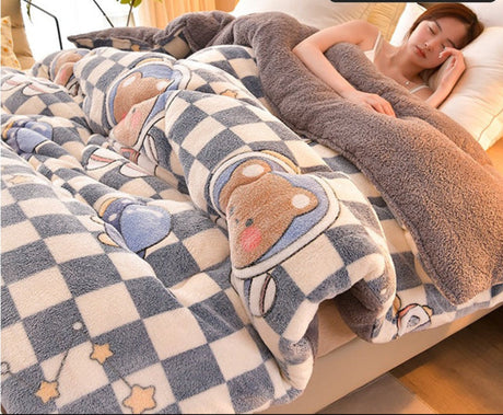 Person lying on a bed with a cartoon bear blanket, surrounded by a cozy bedroom setting.