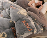 Gray fleece blanket with cartoon character design, featuring text and a woman lying on it.