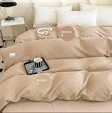 Beige comforter with 'AB double-sided design' on a bed in a bedroom setting.
