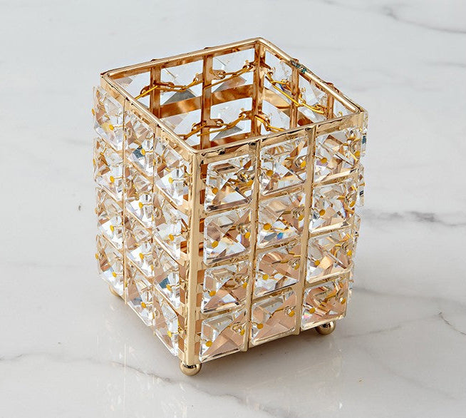 Gold and clear glass decorative box on a marble surface