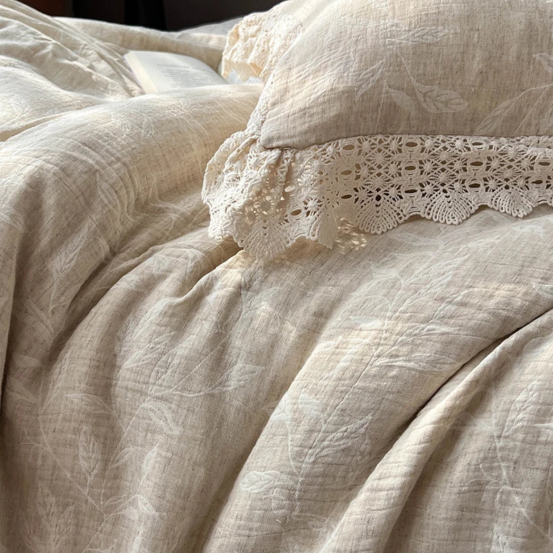 Close-up of beige textured fabric with lace trim, resembling bedding or clothing.