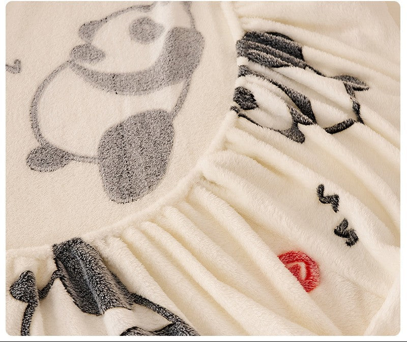 Close-up of a textured fabric with embroidered designs on a white background