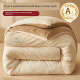 Beige quilt with Class A antibacterial milk fleece label on a beige background