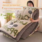 Person wrapped in a plush blanket with cartoon designs, sitting on a couch.