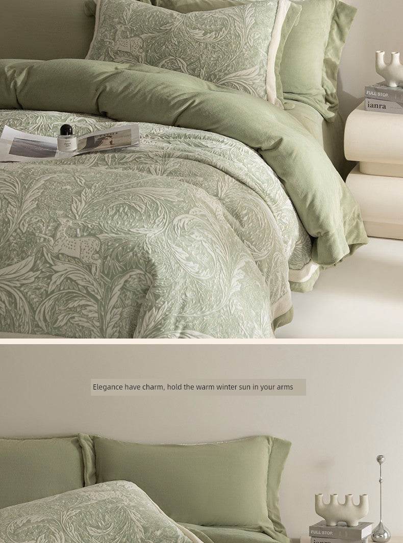 Green patterned bedding set on a bed with decorative pillows and a nightstand.