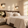Modern bedroom with a bed, nightstands, and wall lamps.